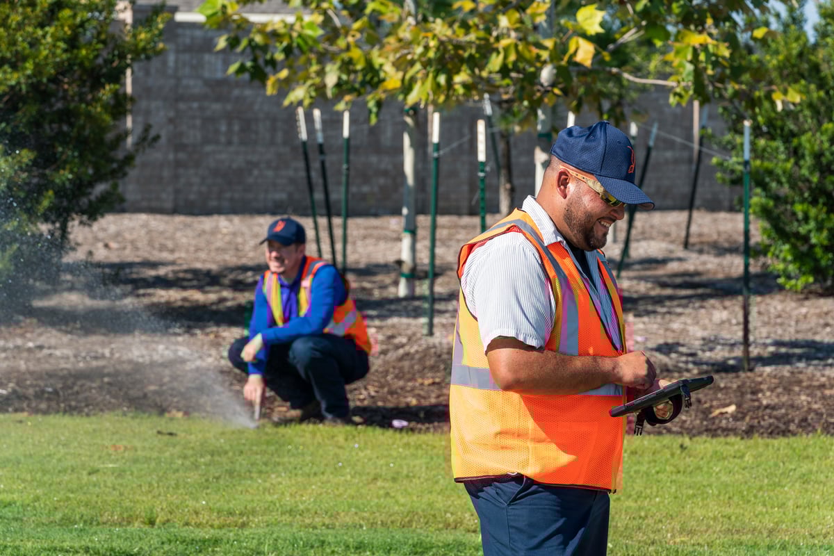 irrigation technicians inspect sprinkler system