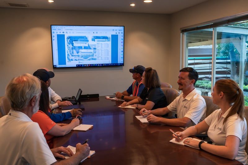 customer and clients meet with landscape plans on television