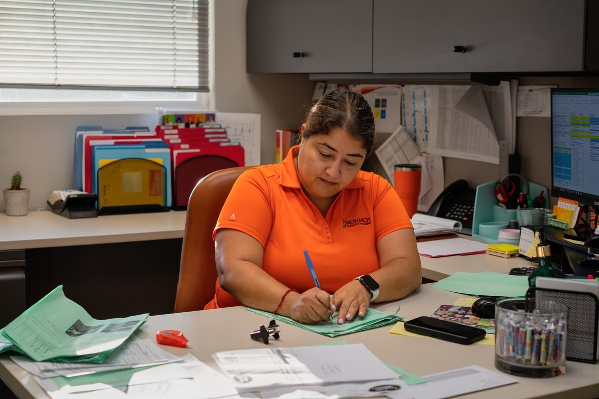 manager works at desk at landscaping company
