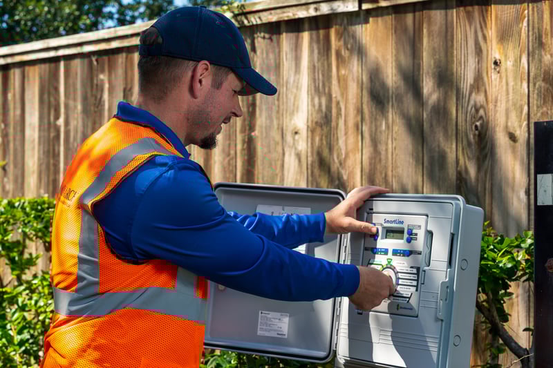 irrigation technician sets smart water management controls