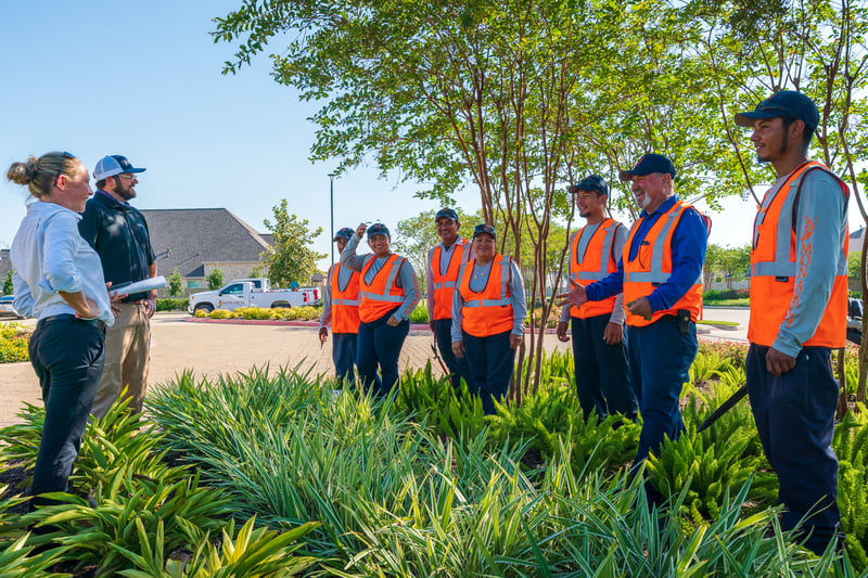 commercial landscaping team meets with customer