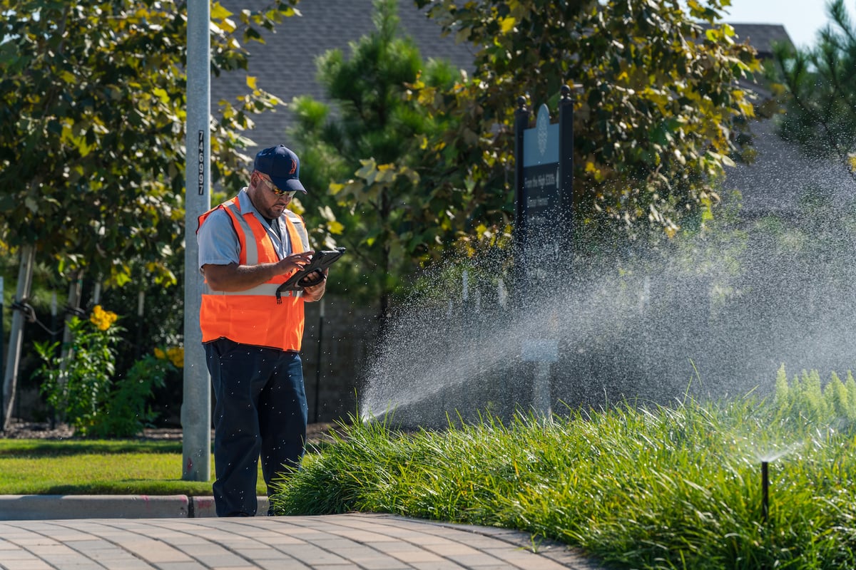 irrigation technician adjust sprinklers