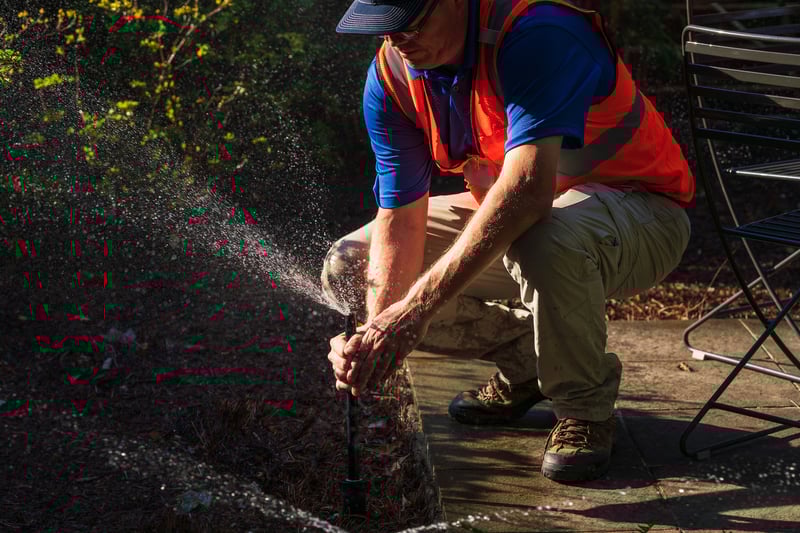 irrigation technician adjust sprinkler head