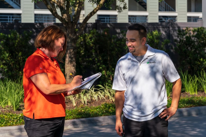 property manager and landscape account manager meet on property